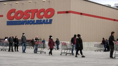 Shoppers Practicing Physical Distancing While Lining Up Outside Costco Store Stock Photos