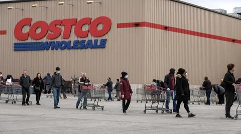 Shoppers Practicing Physical Distancing While Lining Up Outside Costco Store Stock Photos