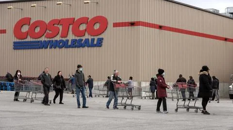 Shoppers Practicing Physical Distancing While Lining Up Outside Costco Store Stock Photos