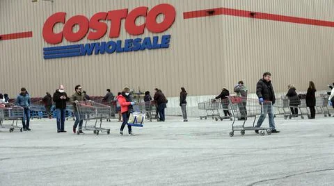 Shoppers Practicing Physical Distancing While Lining Up Outside Costco Store Stock Photos
