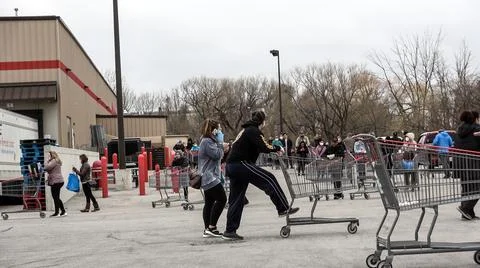 Shoppers Practicing Physical Distancing While Lining Up Outside Costco Store Stock Photos