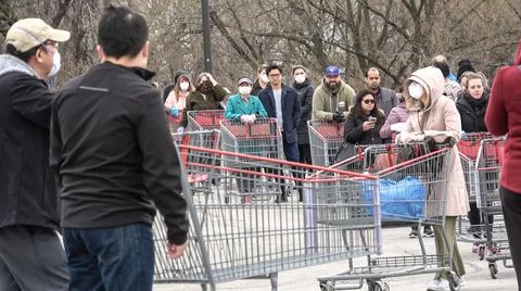 Shoppers Practicing Physical Distancing While Lining Up Outside Costco Store Stock Photos