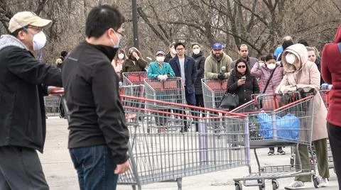 Shoppers Practicing Physical Distancing While Lining Up Outside Costco Store Stock Photos