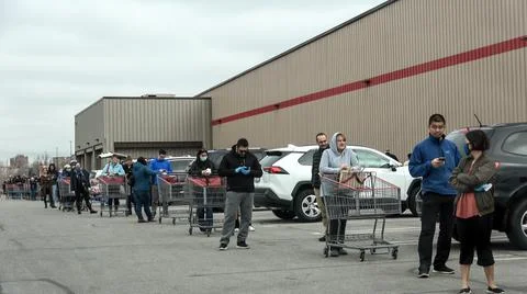 Shoppers Practicing Physical Distancing While Lining Up Outside Costco Store Stock Photos