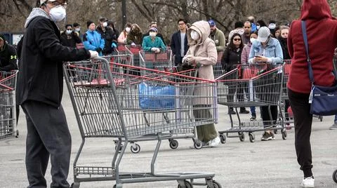 Shoppers Practicing Physical Distancing While Lining Up Outside Costco Store Stock Photos