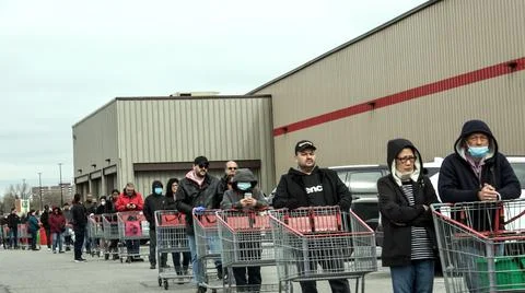 Shoppers Practicing Physical Distancing While Lining Up Outside Costco Store Stock Photos