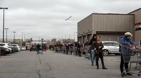 Shoppers Practicing Physical Distancing While Lining Up Outside Costco Store Stock Photos