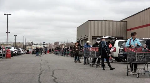 Shoppers Practicing Physical Distancing While Lining Up Outside Costco Store Stock Photos