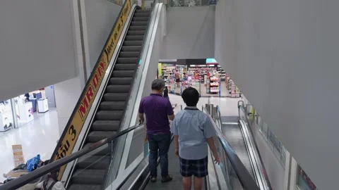 Shoppers Riding Multi Level Escalators in Busy Shopping Mall in Thailand Stock Footage 345512467