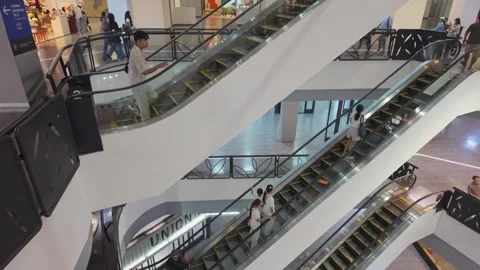 Shoppers Riding Multi Level Escalators Inside Modern Shopping Mall in Bangkok 動画素材 348719368