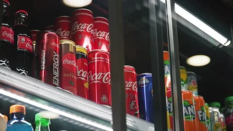 Shoppers take a can of Coca-Cola from the refrigerator of the grocery store Stock Footage 142810374