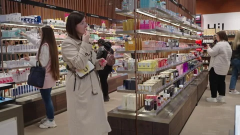 Shoppers testing perfumes and choosing products to buy. Minsk, Belarus, 2023 Stock-Footage 240193076