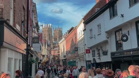 Shoppers walking along Low Petergate York Stock Footage 219326292