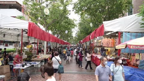 Shoppers walking down open-air market in Singapore Stock Footage 247638169
