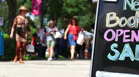 Shoppers walking down a sidewalk Stock Footage 55870660