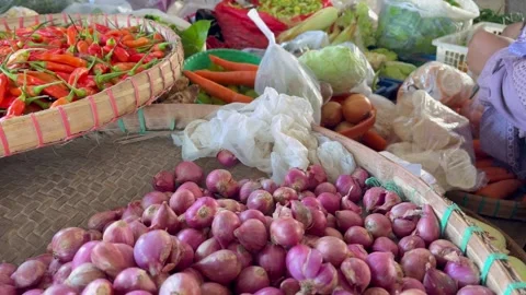 Shopping for basic food needs, onions, carrots, chilies at traditional markets. Video stock 335118135