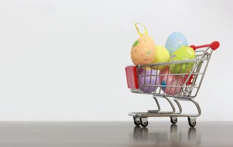 Shopping basket with Easter eggs Stock Photos