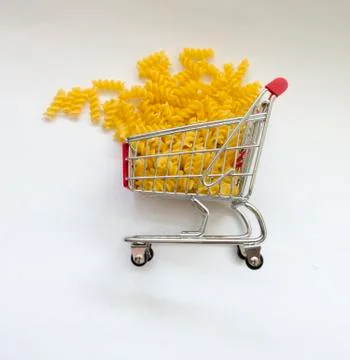 Shopping cart filled with macaroni pasta Stock Photos