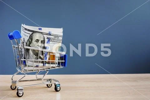 Shopping cart with money. Instant cash loans. Copy space. Stock Photos