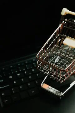 Shopping cart over a computer, concept electronic commerce, e commerce, buy.. Stock Photos