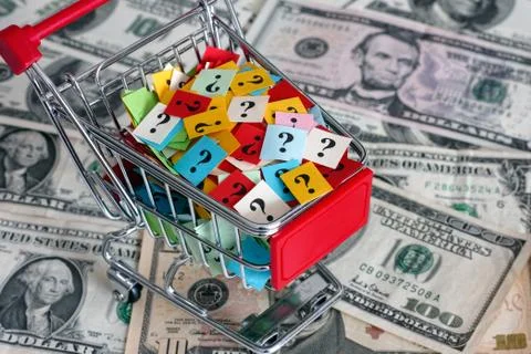 Shopping cart with question marks on dollars banknotes Stock Photos