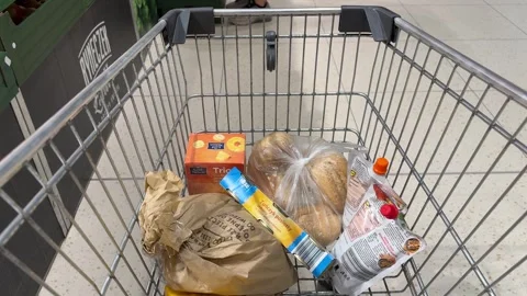 Shopping Cart in Store with Sharp Focus on Cart and Blurred Background Stock Footage 277104878