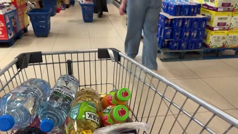 Shopping Cart in Store with Sharp Focus on Cart and Blurred Background Stock Footage 277105292
