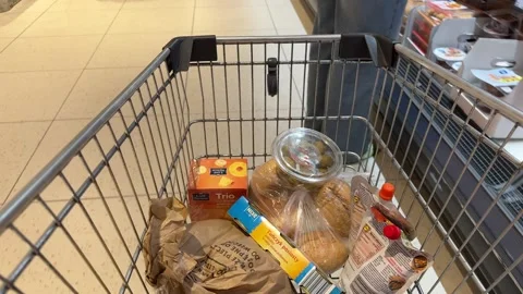 Shopping Cart in Store with Sharp Focus on Cart and Blurred Background Stock Footage 277105352