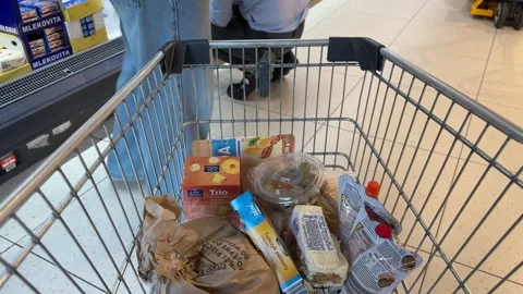 Shopping Cart in Store with Sharp Focus on Cart and Blurred Background Stock Footage 277105362