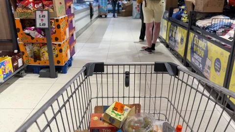 Shopping Cart in Store with Sharp Focus on Cart and Blurred Background Stock Footage 277105397