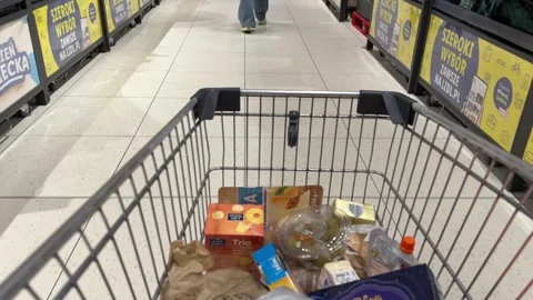 Shopping Cart in Store with Sharp Focus on Cart and Blurred Background Stock Footage 277105414