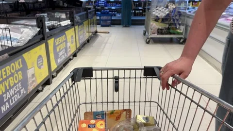 Shopping Cart in Store with Sharp Focus on Cart and Blurred Background Stock Footage 277105415