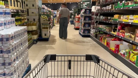 Shopping Cart in Store with Sharp Focus on Cart and Blurred Background Stock Footage 277105416