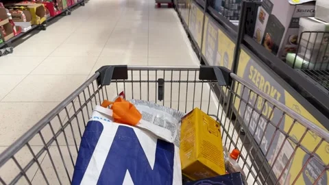 Shopping Cart in Store with Sharp Focus on Cart and Blurred Background Stock Footage 277105433