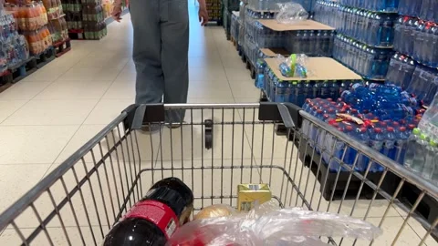 Shopping Cart in Store with Sharp Focus on Cart and Blurred Background Stock Footage 277105506