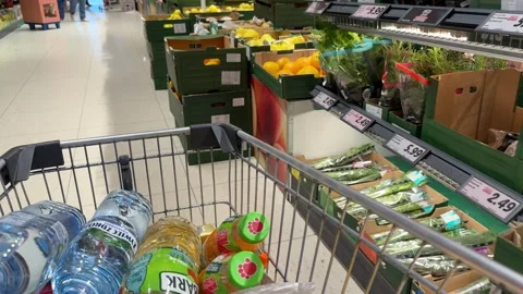 Shopping Cart in Store with Sharp Focus on Cart and Blurred Background Stock Footage 277105545