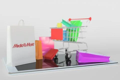 Shopping cart on a tablet computer and paper bag with Media Markt logo 스톡 일러스트