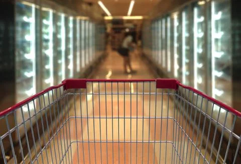 Shopping cart view in Supermarket Aisle with product shelves in blurry for ba Stock Photos