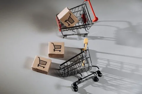 Shopping carts and boxes on white background. Top view Stock Photos