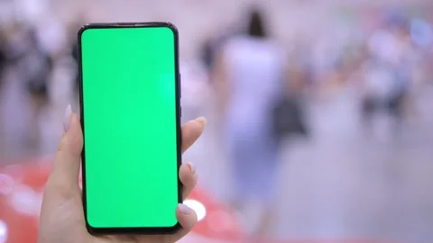 Shopping center. Mall. Back view of brunette holding chroma key green screen Stock Footage 276590200