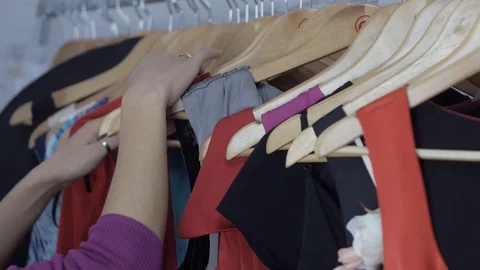 Shopping choice of clothes on a hanger Stock Footage 74874004