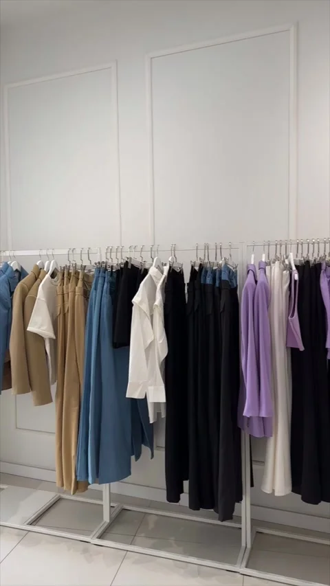 Shopping. Clothing rack features an array of stylish garments in a retail space Video stock 339040451