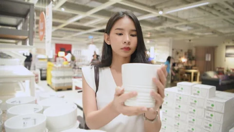 Shopping concept of 4k Resolution. Asian woman choosing a vase in the mall. Stock Footage 314910331