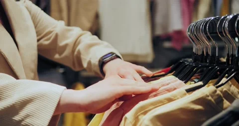 Shopping Concept. Close-up of hands run across a rack of clothes. 库存影片 152827199