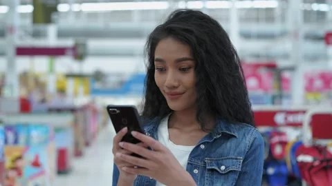 Shopping concepts of 4k Resolution. Young women use mobile phones to search f Stock Footage 151491555