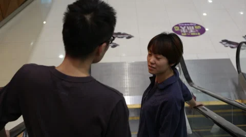 Shopping couple going down by escalator. Stock Footage 31739010