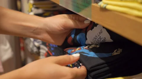 Shopping Female Hands and Stack of Folded Clothes Stock Footage 57615158