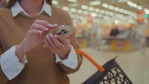Shopping for groceries while checking a shopping list at a supermarket during Stock Footage 293672758