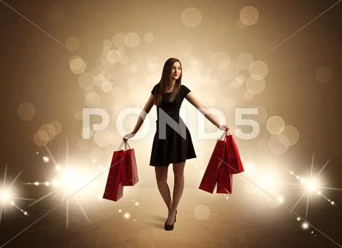 Shopping lady with bags in bright lights Stock Photos