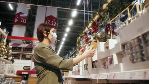 Shopping mall staff checking the quality of Christmas goods before winter sales Stock Footage 142086400